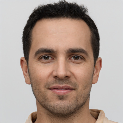 Joyful white young-adult male with short  brown hair and brown eyes