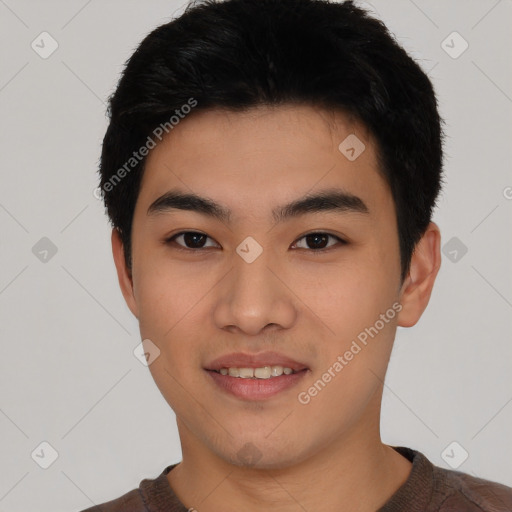 Joyful asian young-adult male with short  black hair and brown eyes