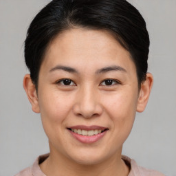 Joyful asian young-adult female with short  brown hair and brown eyes