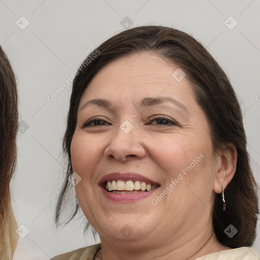 Joyful white adult female with medium  brown hair and brown eyes