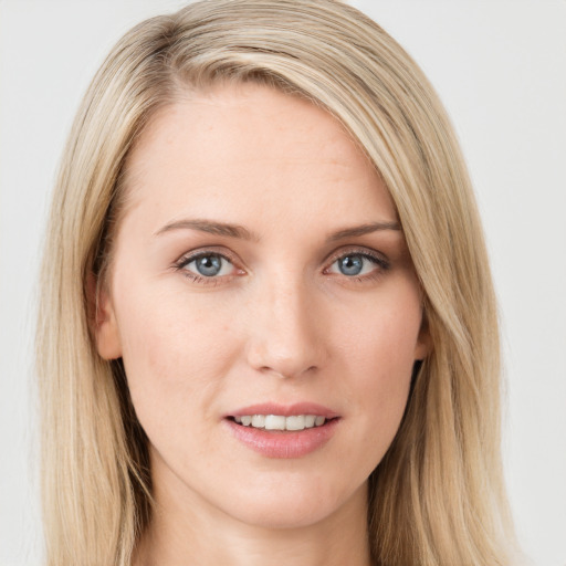 Joyful white young-adult female with long  brown hair and blue eyes