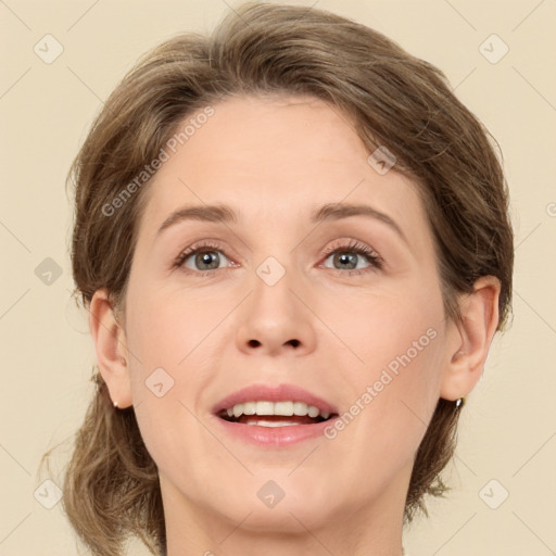 Joyful white adult female with medium  brown hair and green eyes