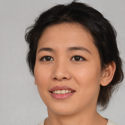 Joyful asian young-adult female with medium  brown hair and brown eyes