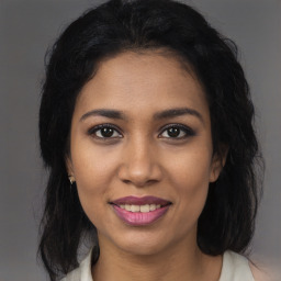 Joyful latino young-adult female with medium  brown hair and brown eyes