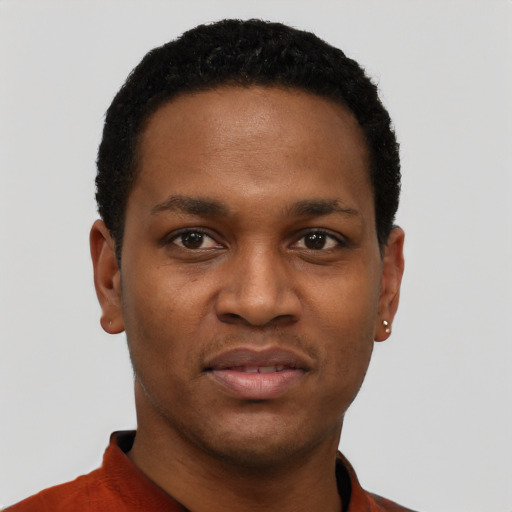 Joyful black young-adult male with short  black hair and brown eyes