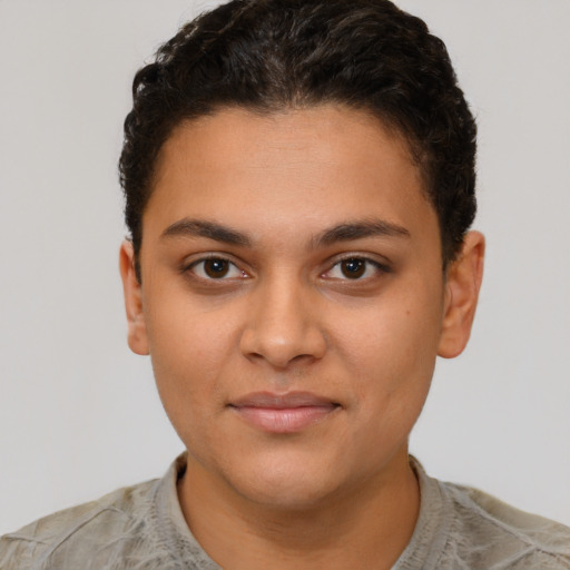 Joyful latino young-adult female with short  brown hair and brown eyes