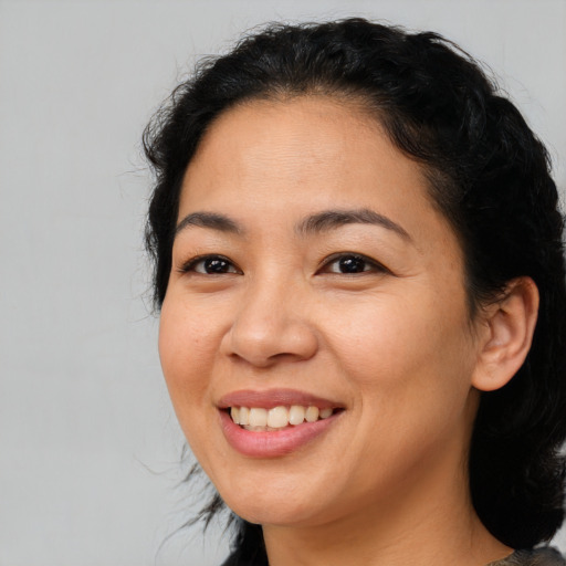 Joyful asian young-adult female with medium  black hair and brown eyes
