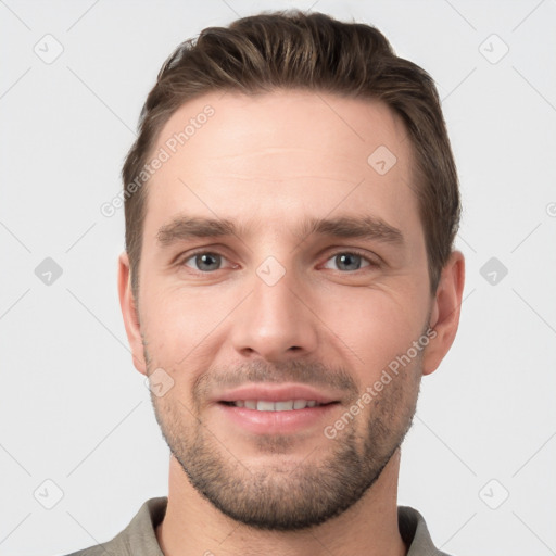 Joyful white young-adult male with short  brown hair and grey eyes