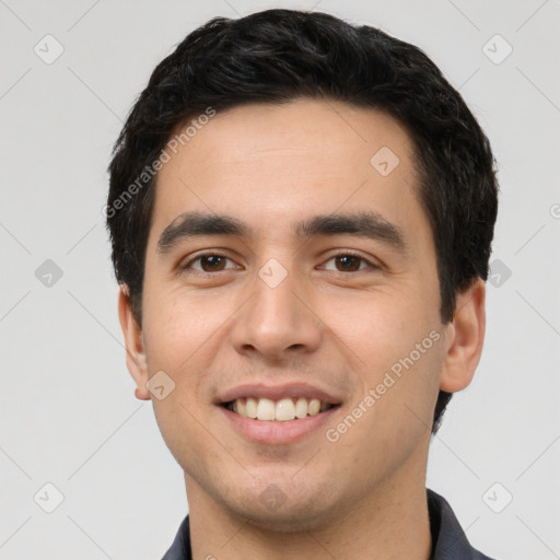 Joyful white young-adult male with short  black hair and brown eyes