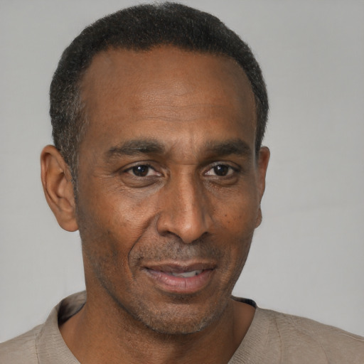 Joyful latino adult male with short  black hair and brown eyes