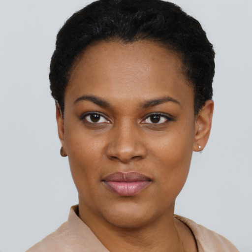 Joyful black young-adult female with short  black hair and brown eyes