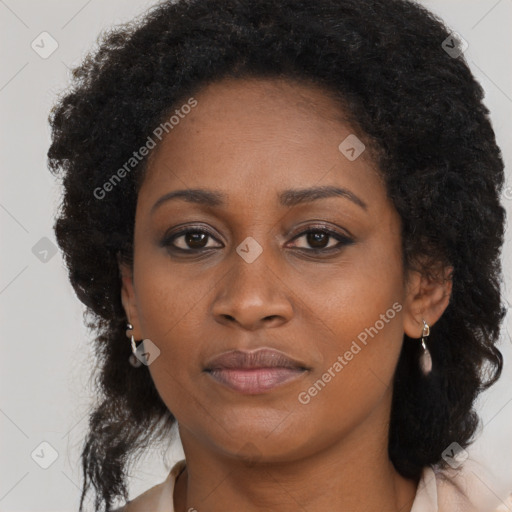 Joyful black young-adult female with long  brown hair and brown eyes