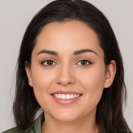 Joyful white young-adult female with long  brown hair and brown eyes