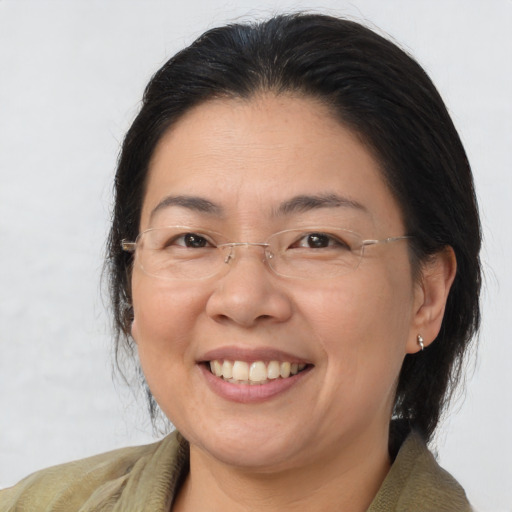 Joyful asian adult female with medium  brown hair and brown eyes
