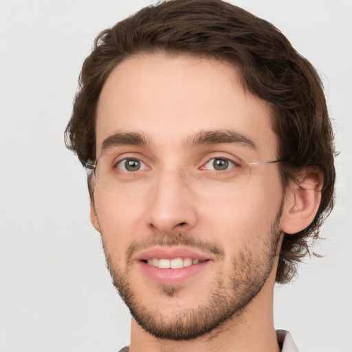 Joyful white young-adult male with short  brown hair and green eyes