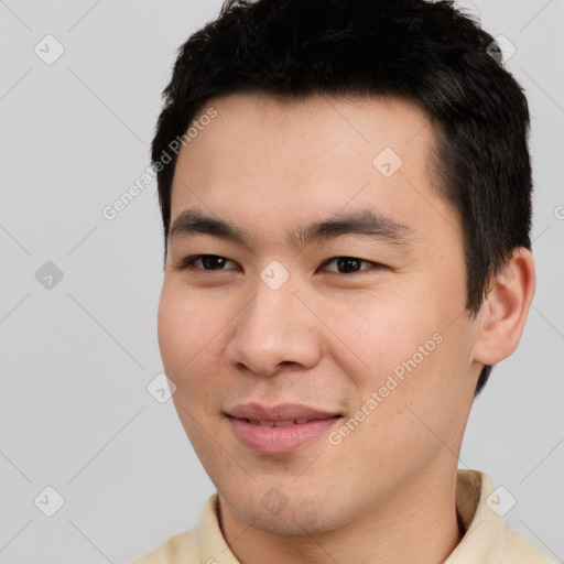 Joyful asian young-adult male with short  black hair and brown eyes