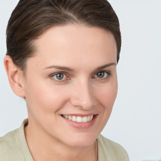 Joyful white young-adult female with short  brown hair and brown eyes