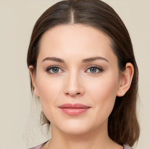 Joyful white young-adult female with medium  brown hair and brown eyes