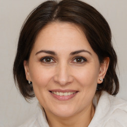 Joyful white adult female with medium  brown hair and brown eyes