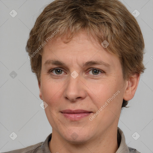 Joyful white adult male with short  brown hair and grey eyes