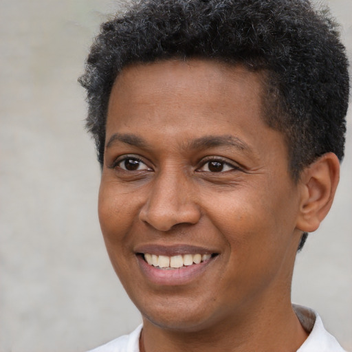Joyful black young-adult male with short  brown hair and brown eyes