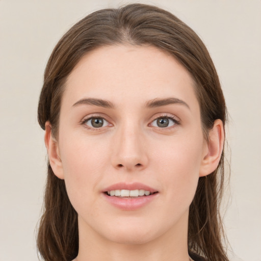 Joyful white young-adult female with medium  brown hair and green eyes