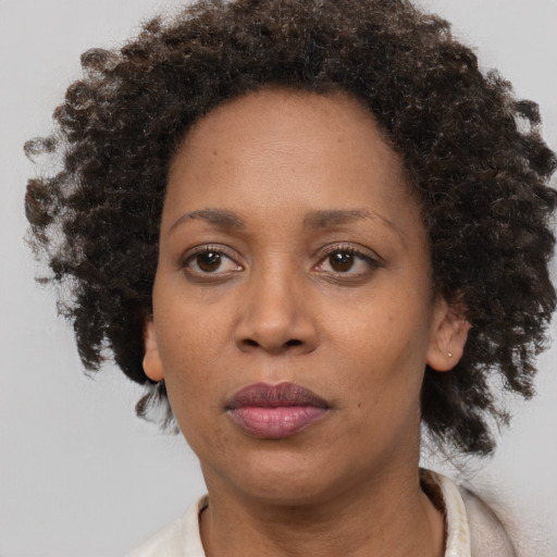 Neutral black adult female with medium  brown hair and brown eyes