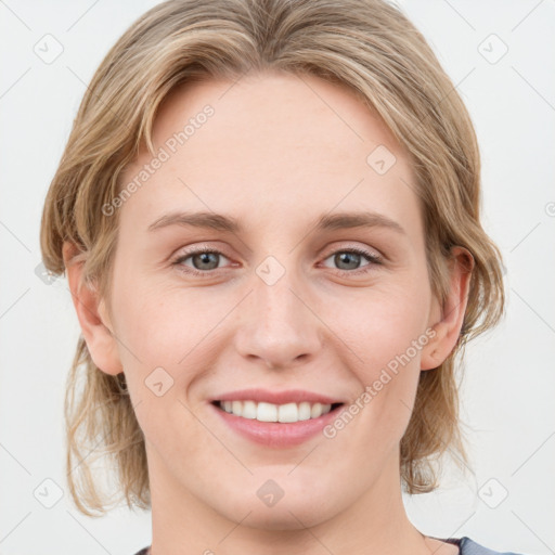 Joyful white young-adult female with medium  brown hair and blue eyes