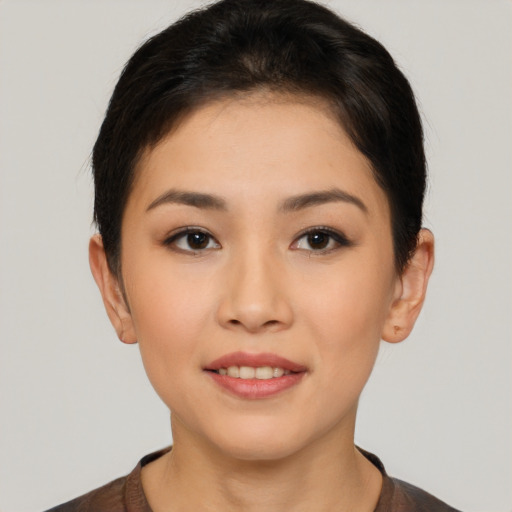 Joyful asian young-adult female with short  brown hair and brown eyes