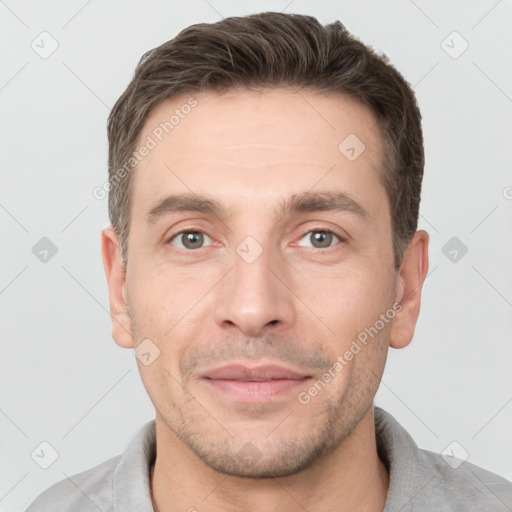 Joyful white young-adult male with short  brown hair and brown eyes