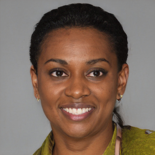 Joyful black young-adult female with short  black hair and brown eyes