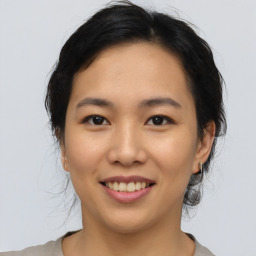 Joyful asian young-adult female with medium  brown hair and brown eyes