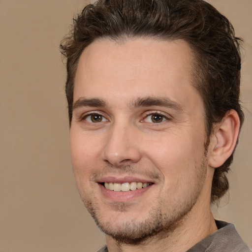 Joyful white adult male with short  brown hair and brown eyes