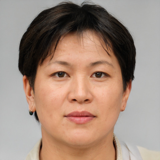 Joyful asian adult female with short  brown hair and brown eyes