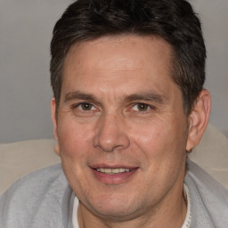 Joyful white adult male with short  brown hair and brown eyes