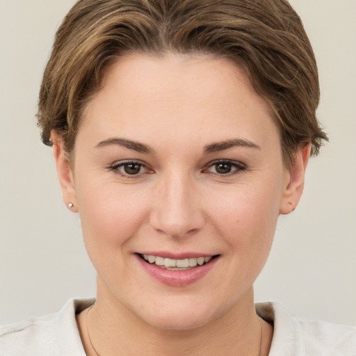 Joyful white young-adult female with short  brown hair and brown eyes