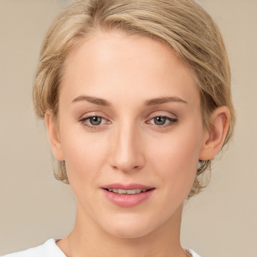 Joyful white young-adult female with medium  brown hair and blue eyes