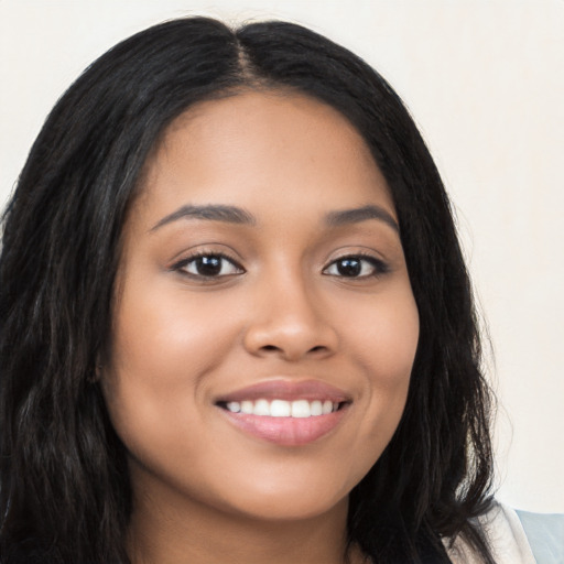 Joyful latino young-adult female with long  black hair and brown eyes