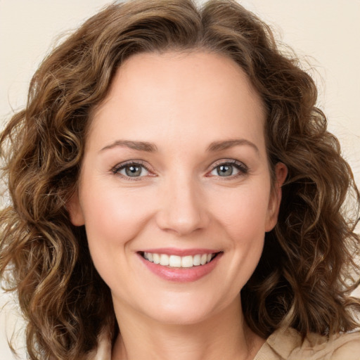 Joyful white young-adult female with medium  brown hair and green eyes