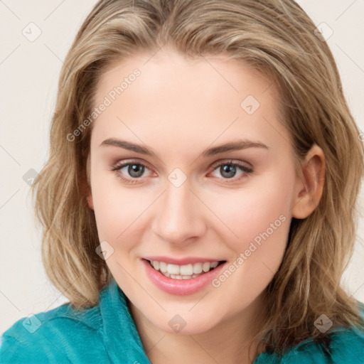 Joyful white young-adult female with long  brown hair and green eyes