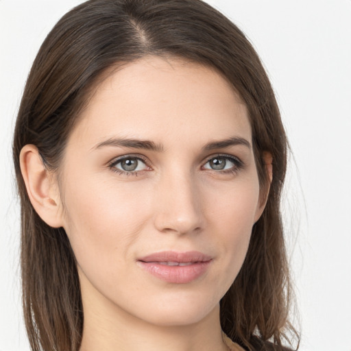 Joyful white young-adult female with long  brown hair and grey eyes