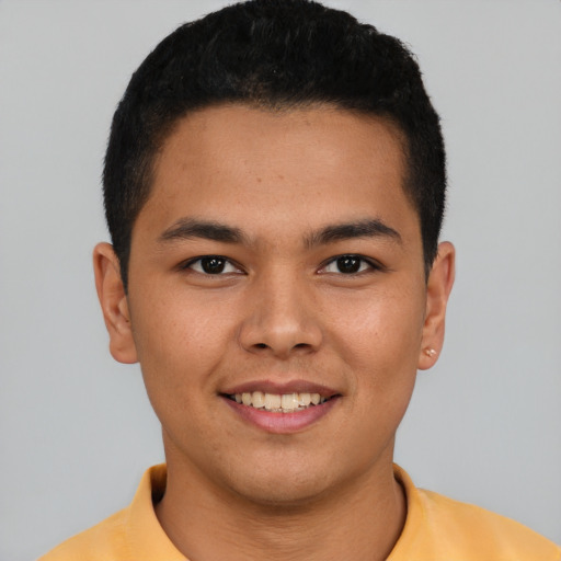 Joyful latino young-adult male with short  brown hair and brown eyes