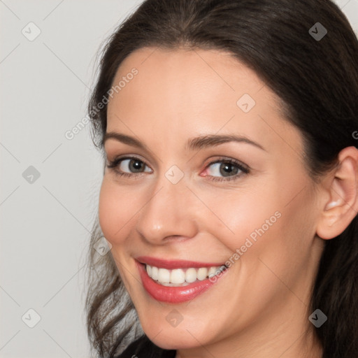 Joyful white young-adult female with long  brown hair and brown eyes