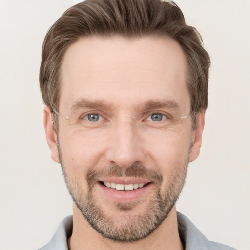 Joyful white adult male with short  brown hair and grey eyes