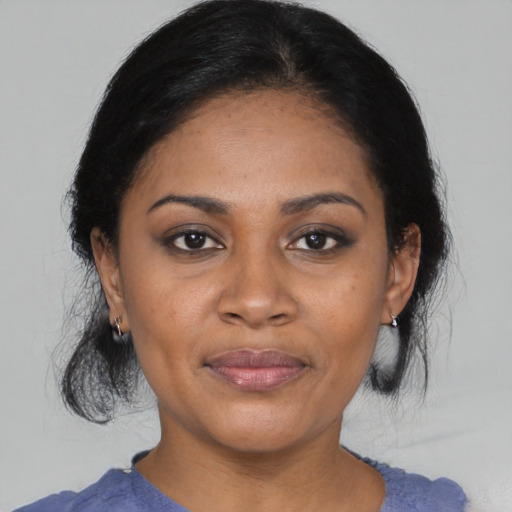 Joyful black adult female with medium  black hair and brown eyes