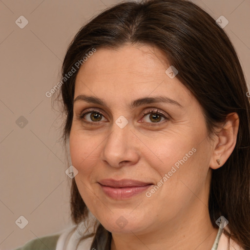 Joyful white adult female with medium  brown hair and brown eyes