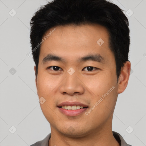 Joyful asian young-adult male with short  black hair and brown eyes