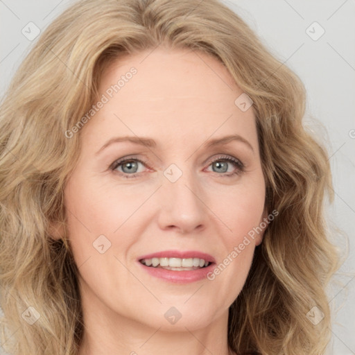 Joyful white adult female with long  brown hair and blue eyes