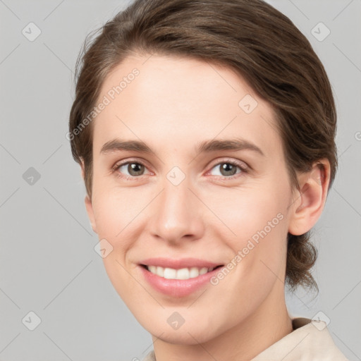 Joyful white young-adult female with medium  brown hair and grey eyes