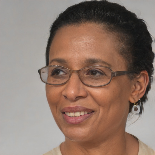 Joyful black adult female with medium  brown hair and brown eyes